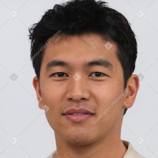 Joyful asian young-adult male with short  black hair and brown eyes