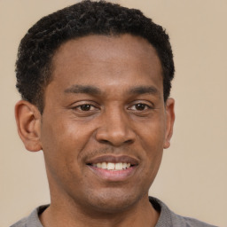 Joyful latino young-adult male with short  brown hair and brown eyes