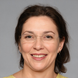 Joyful white adult female with medium  brown hair and brown eyes