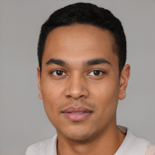 Joyful latino young-adult male with short  black hair and brown eyes