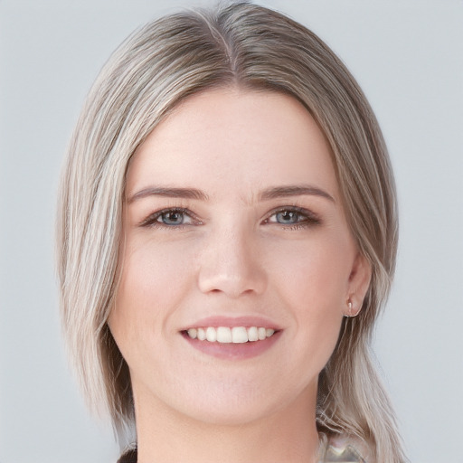 Joyful white young-adult female with long  brown hair and blue eyes