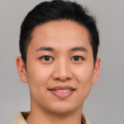 Joyful asian young-adult male with short  brown hair and brown eyes