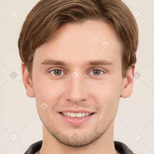 Joyful white young-adult male with short  brown hair and grey eyes