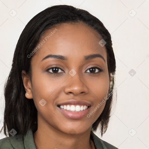 Joyful black young-adult female with long  black hair and brown eyes