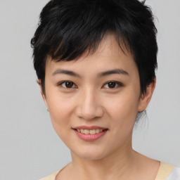 Joyful asian young-adult female with short  black hair and brown eyes