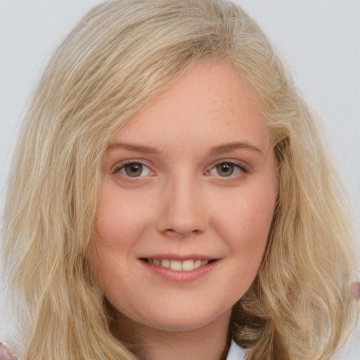 Joyful white young-adult female with medium  blond hair and blue eyes