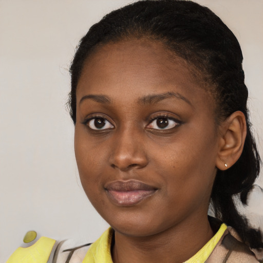 Joyful black young-adult female with medium  brown hair and brown eyes