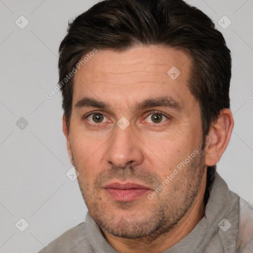 Joyful white adult male with short  brown hair and brown eyes