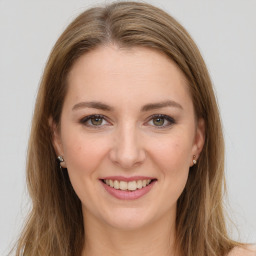 Joyful white young-adult female with long  brown hair and green eyes