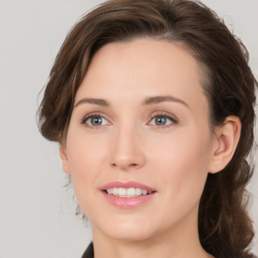 Joyful white young-adult female with medium  brown hair and grey eyes