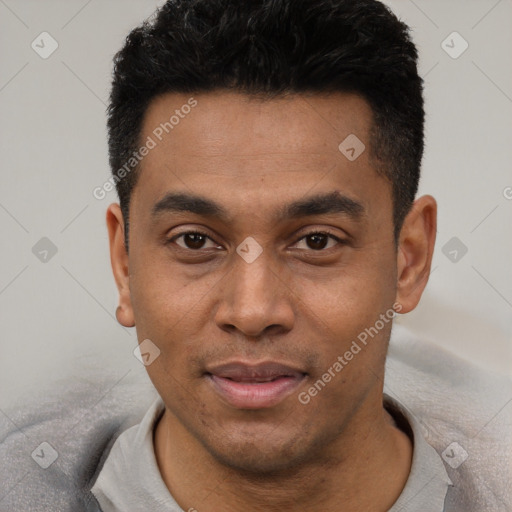 Joyful latino young-adult male with short  black hair and brown eyes