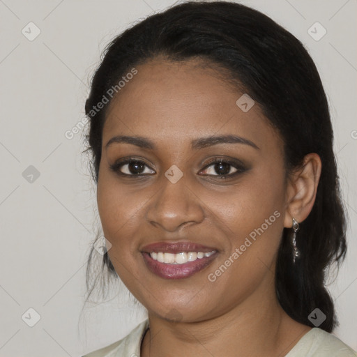 Joyful black young-adult female with long  brown hair and brown eyes