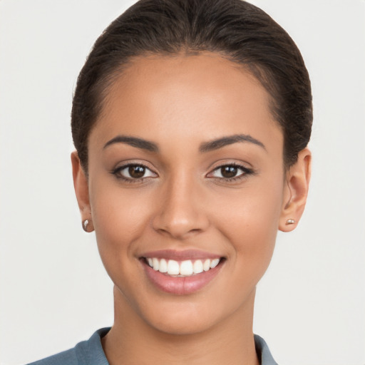 Joyful latino young-adult female with short  brown hair and brown eyes