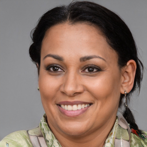 Joyful latino adult female with medium  brown hair and brown eyes