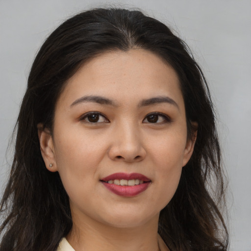 Joyful asian young-adult female with long  brown hair and brown eyes