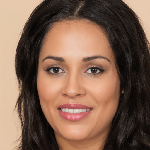 Joyful latino young-adult female with long  brown hair and brown eyes