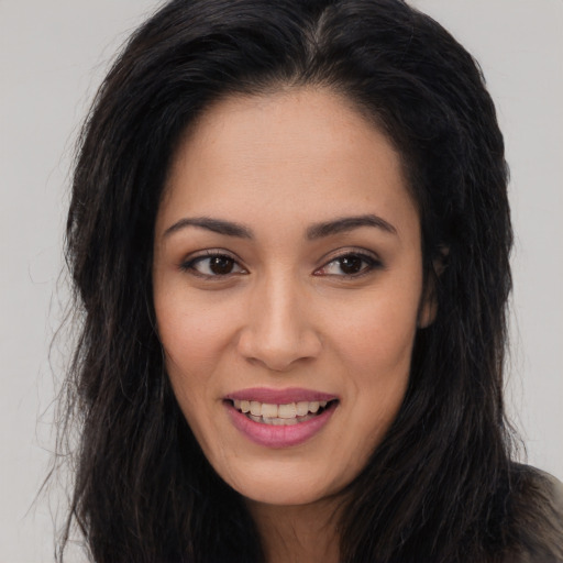 Joyful white young-adult female with long  brown hair and brown eyes