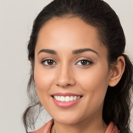 Joyful white young-adult female with long  brown hair and brown eyes