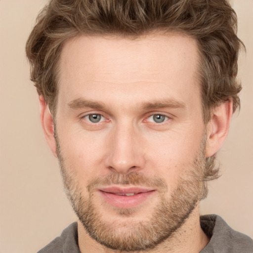 Joyful white adult male with short  brown hair and grey eyes