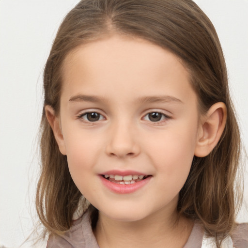 Joyful white child female with medium  brown hair and brown eyes