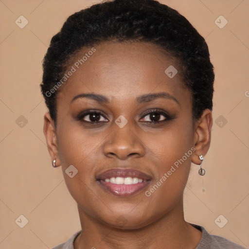 Joyful black young-adult female with short  brown hair and brown eyes