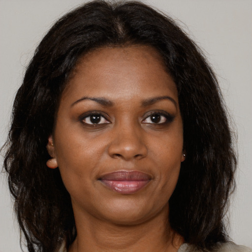Joyful black young-adult female with medium  brown hair and brown eyes