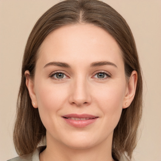 Joyful white young-adult female with medium  brown hair and grey eyes