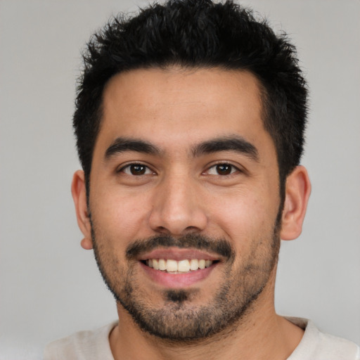 Joyful white young-adult male with short  black hair and brown eyes