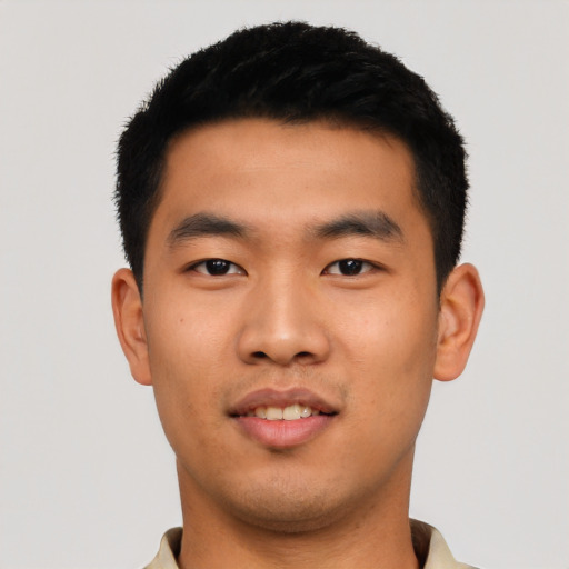 Joyful asian young-adult male with short  black hair and brown eyes