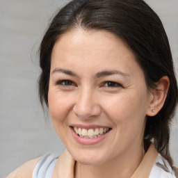 Joyful white adult female with medium  brown hair and brown eyes