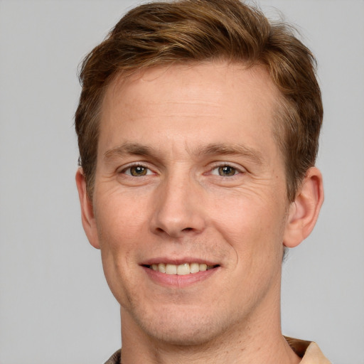 Joyful white adult male with short  brown hair and grey eyes