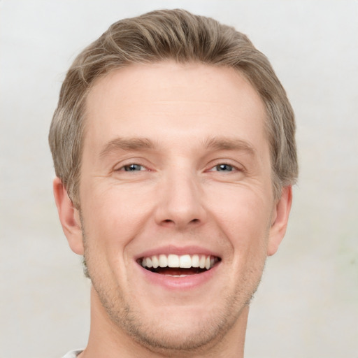 Joyful white adult male with short  brown hair and grey eyes