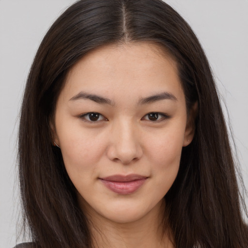 Joyful asian young-adult female with long  brown hair and brown eyes
