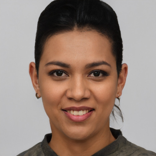 Joyful latino young-adult female with short  black hair and brown eyes