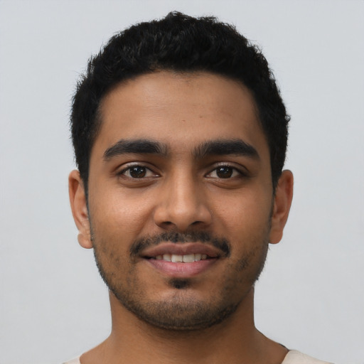 Joyful latino young-adult male with short  black hair and brown eyes