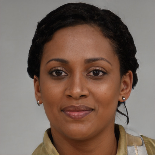 Joyful black young-adult female with short  brown hair and brown eyes