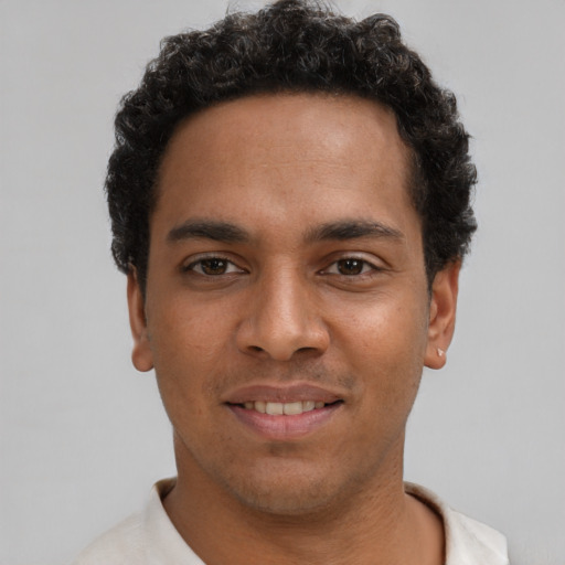 Joyful latino young-adult male with short  brown hair and brown eyes