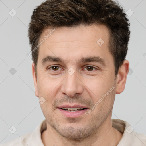 Joyful white adult male with short  brown hair and brown eyes