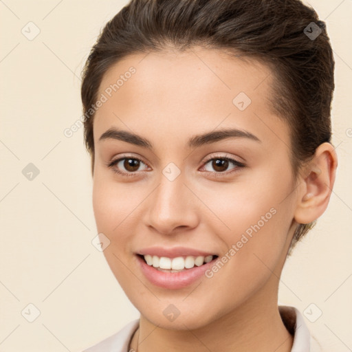 Joyful white young-adult female with short  brown hair and brown eyes