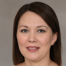 Joyful white adult female with medium  brown hair and brown eyes