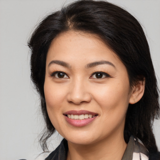 Joyful asian young-adult female with medium  brown hair and brown eyes