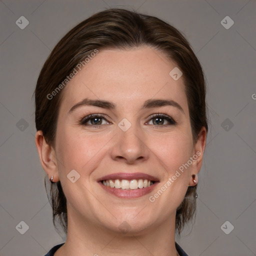 Joyful white young-adult female with medium  brown hair and grey eyes