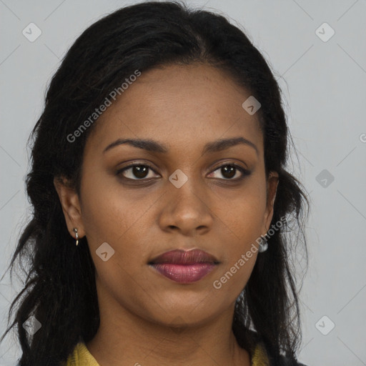 Joyful black young-adult female with long  brown hair and brown eyes
