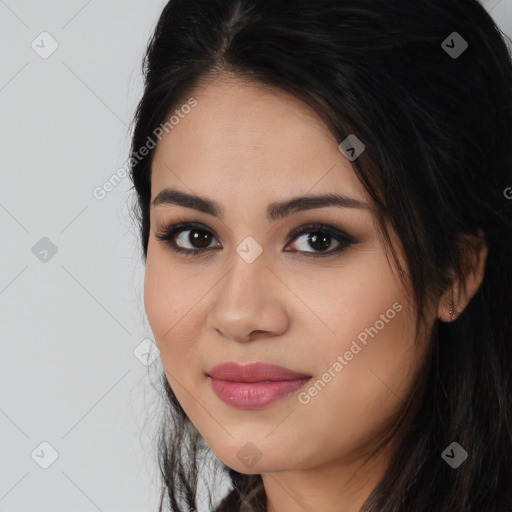 Joyful latino young-adult female with long  brown hair and brown eyes