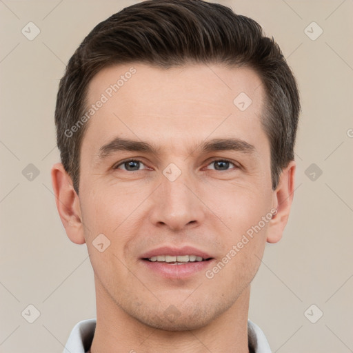 Joyful white young-adult male with short  brown hair and grey eyes