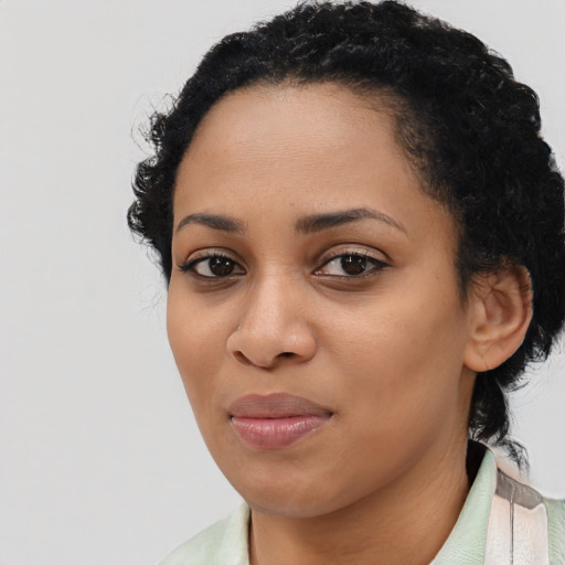 Joyful black young-adult female with medium  black hair and brown eyes