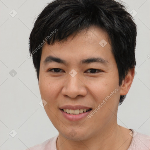 Joyful asian young-adult male with short  brown hair and brown eyes