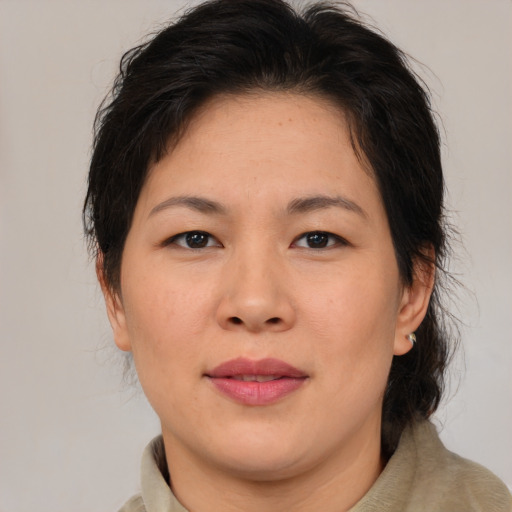 Joyful asian adult female with medium  brown hair and brown eyes