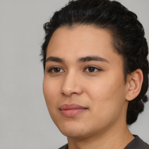 Joyful latino young-adult female with short  black hair and brown eyes