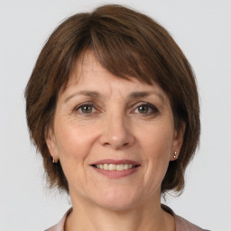 Joyful white adult female with medium  brown hair and brown eyes